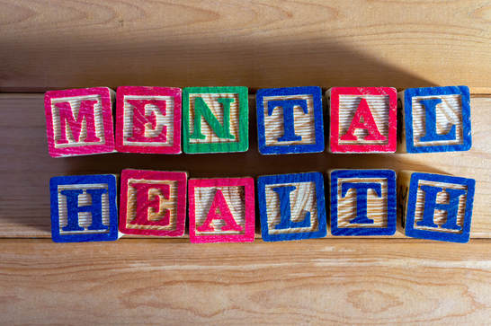 The words mental health spelled out in wooden letter blocks